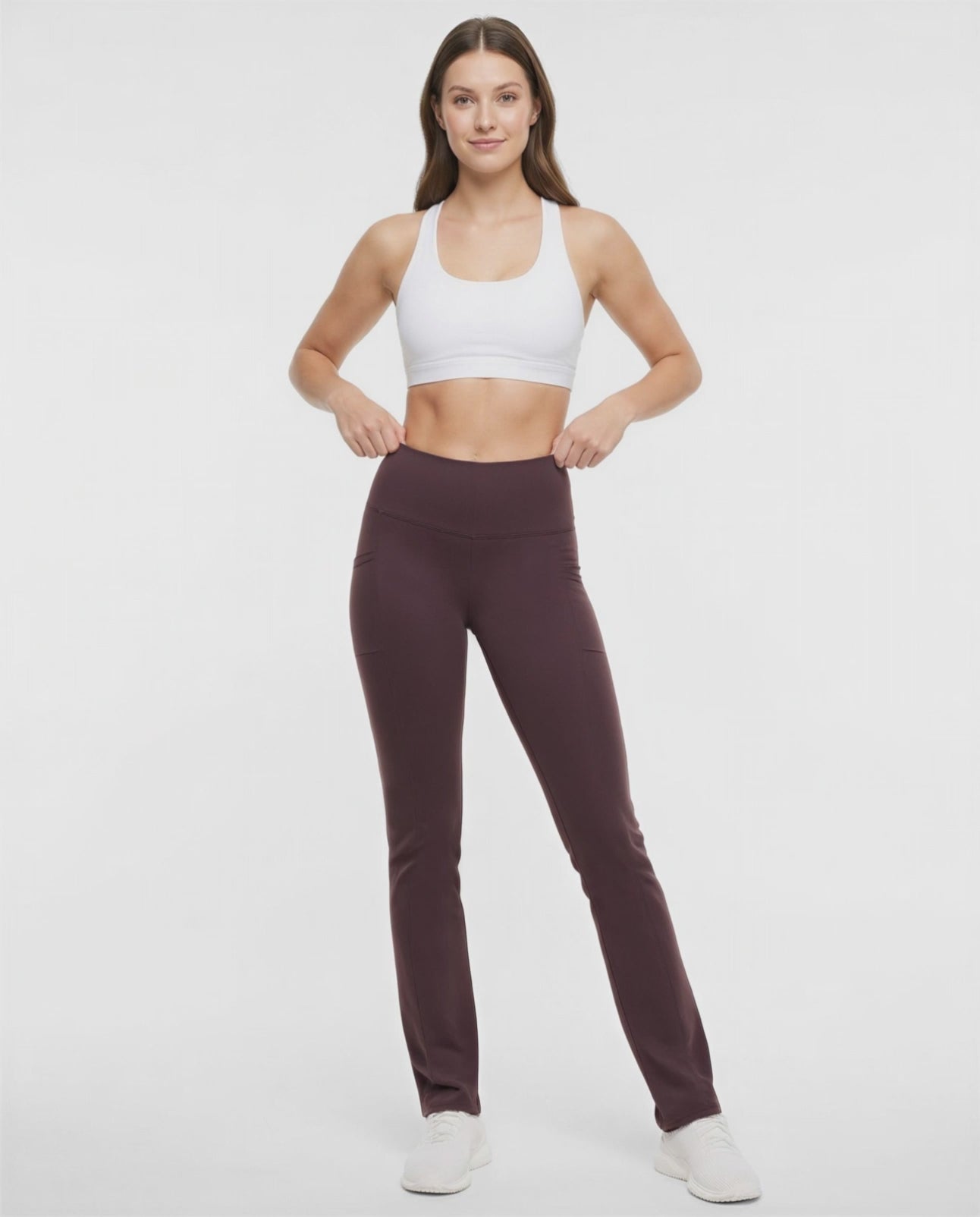 Video view of woman wearing brown yoga pants with a plain background. #color_black-coffee