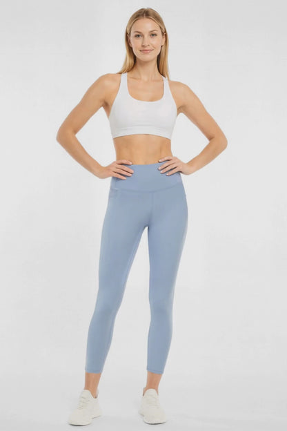 Video view of woman wearing light blue leggings worn by a person on a white background. 
