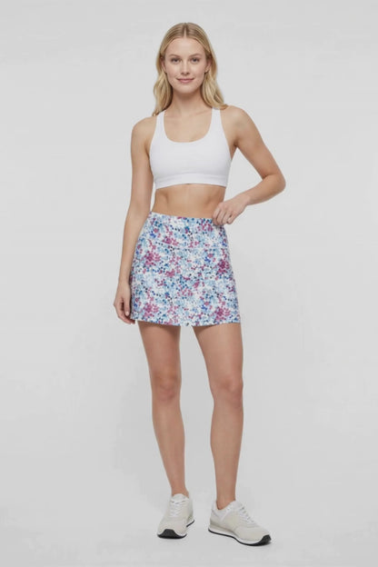 Video view of woman wearing spotted floral patterned skort design on a white background. 