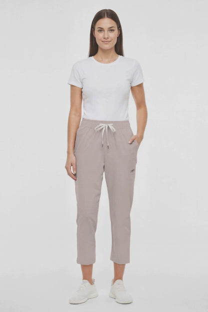 Video view of beige pants worn by a woman with white drawstring waist on a white background. 
