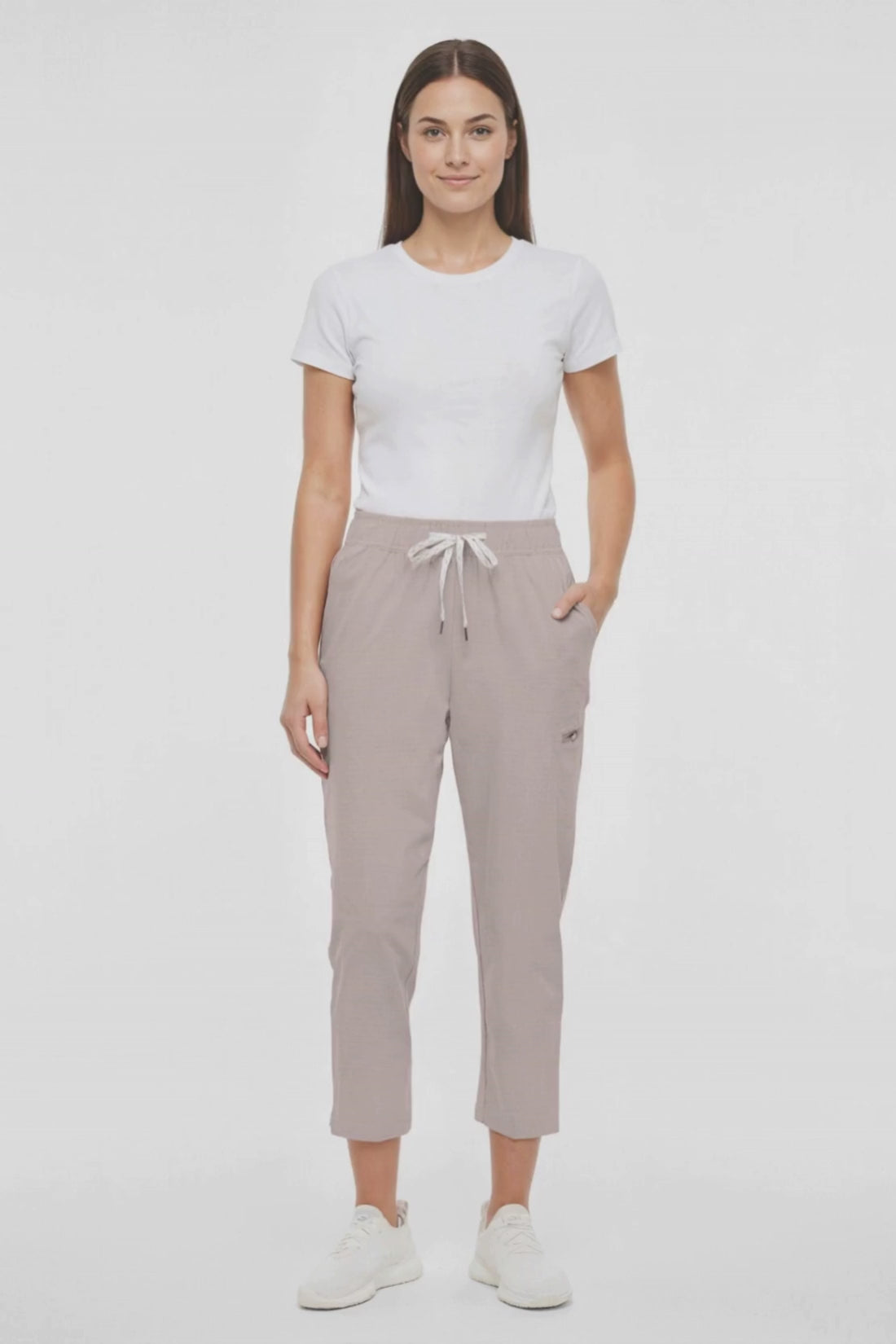 Video view of beige pants worn by a woman with white drawstring waist on a white background. #color_atmosphere