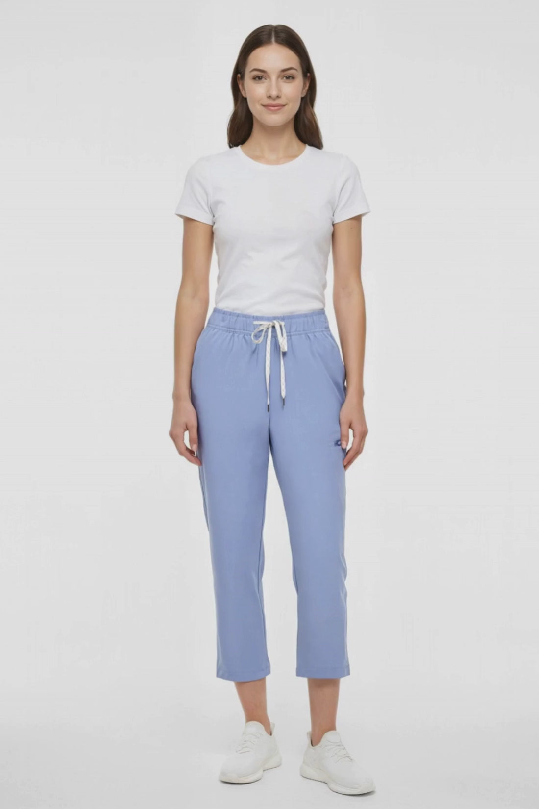 Video view of light blue pants worn by a woman with white drawstring waist on a white background. 
